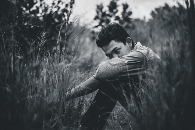 sad teen sitting outdoors