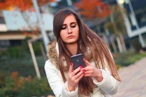 stock image of teen using cell phone