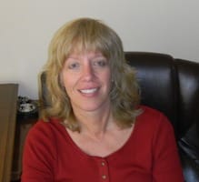 Headshot of Stacie Aden sitting on office chair