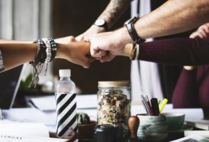 stock image of group of people bumping fists