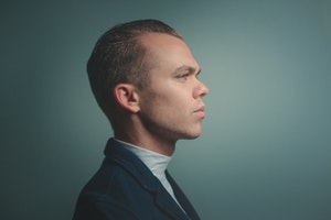 Stock image of man in front of dark background