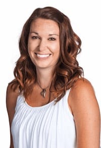 Jill Alexander headshot in front of white background with a white top