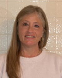 Lindy Steece Headshot indoors while wearing a pink top