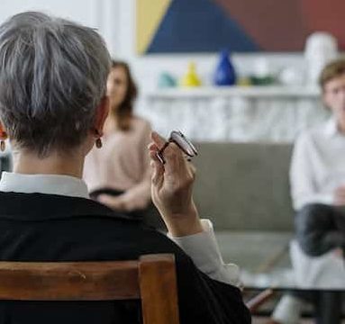 man and woman sitting in front of therapist