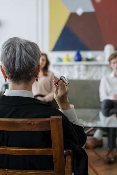 man and woman sitting in front of therapist