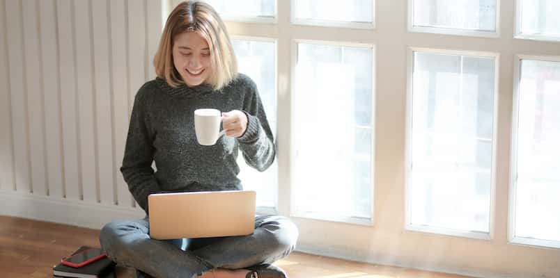 woman sitting with laptop during teletherapy