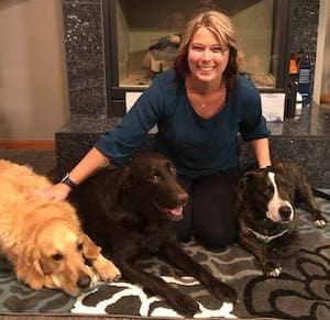 Kimberly indoors with her 3 dogs