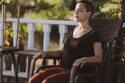 woman sitting in chair meditating to soothe anger