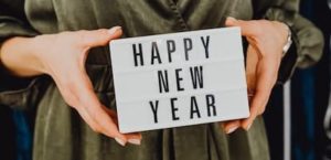 Women holding Happy New Year sign