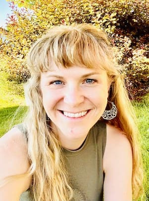 Headshot of Aubrey Adain wearing a green top while outdoors