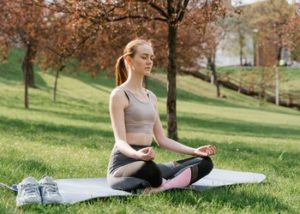 woman outdoors meditating