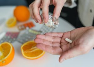 person hold a pill while making food