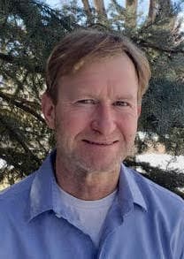 Therapist Jeremy Thomas outdoors wearing a blue shirt