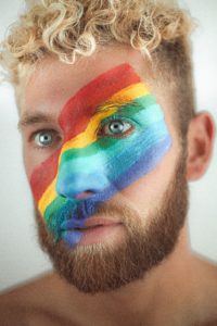 man with lgbt face paint