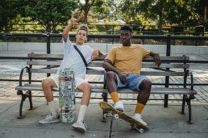 two young men sitting on bench