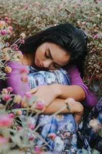 woman sad in flower field